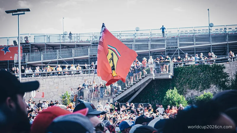 A crowd of people standing around a red flag