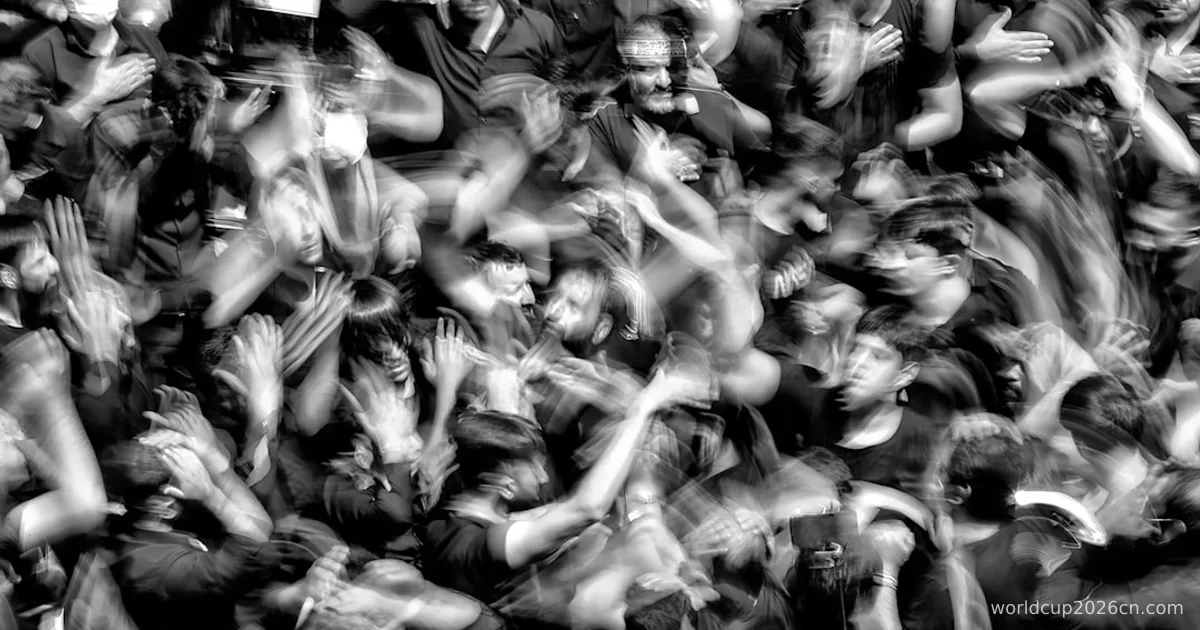 a crowd of people with their hands in the air