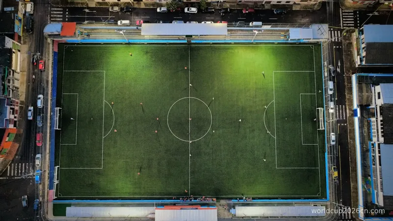 Aerial view of a brightly lit soccer field at night.