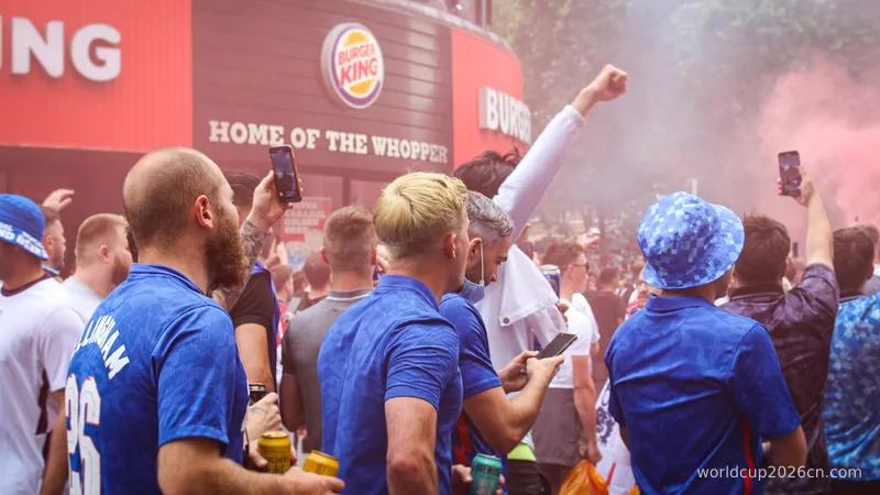 people in blue shirts standing and holding yellow and white powder