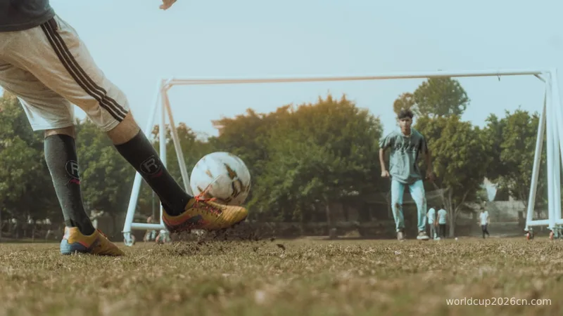 man in white shirt and brown pants playing soccer during daytime