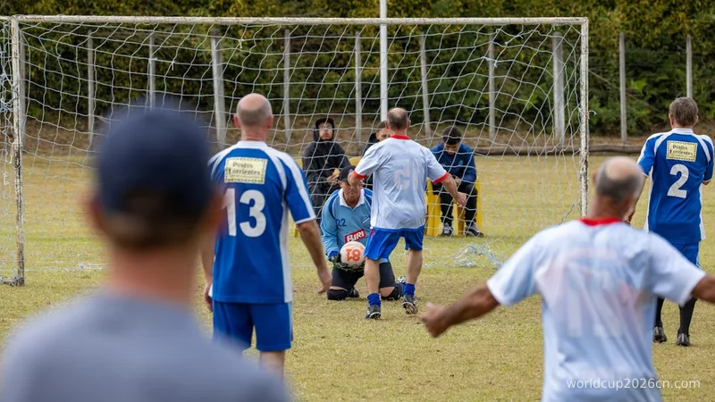 Adult men playing soccer, with a goalie near the net.