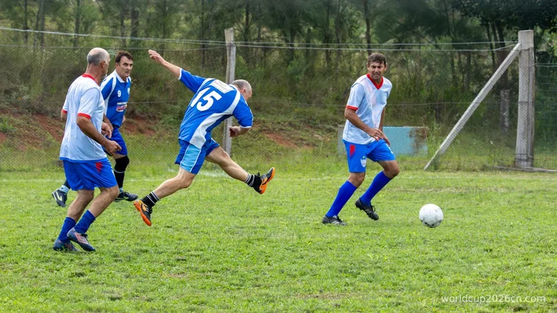 Men playing soccer on a grassy field