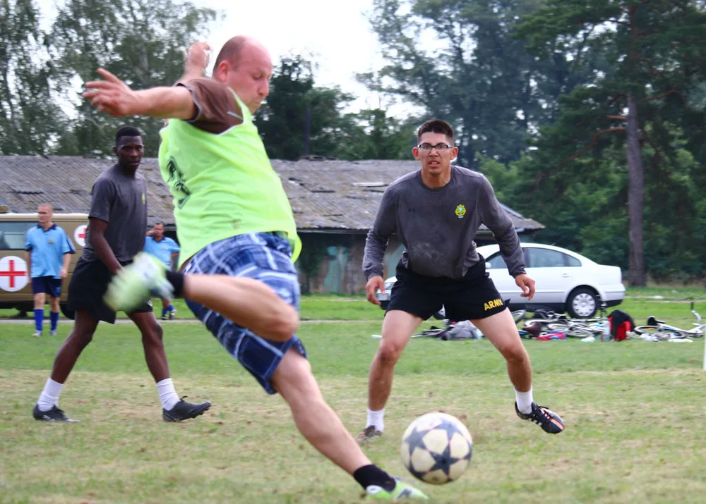 Close up shot of generic football match action, blurred player silhouettes runni
