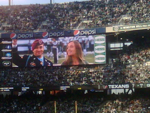Blurred background of football fans wearing generic jerseys cheering in a stadiu