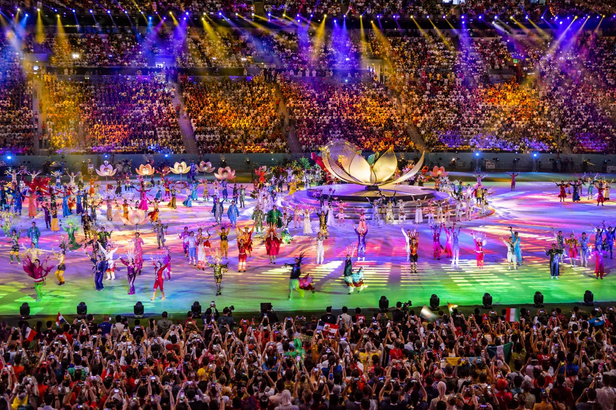 Vibrant opening ceremony stage of a FIFA World Cup, colorful dynamic lighting, large crowd